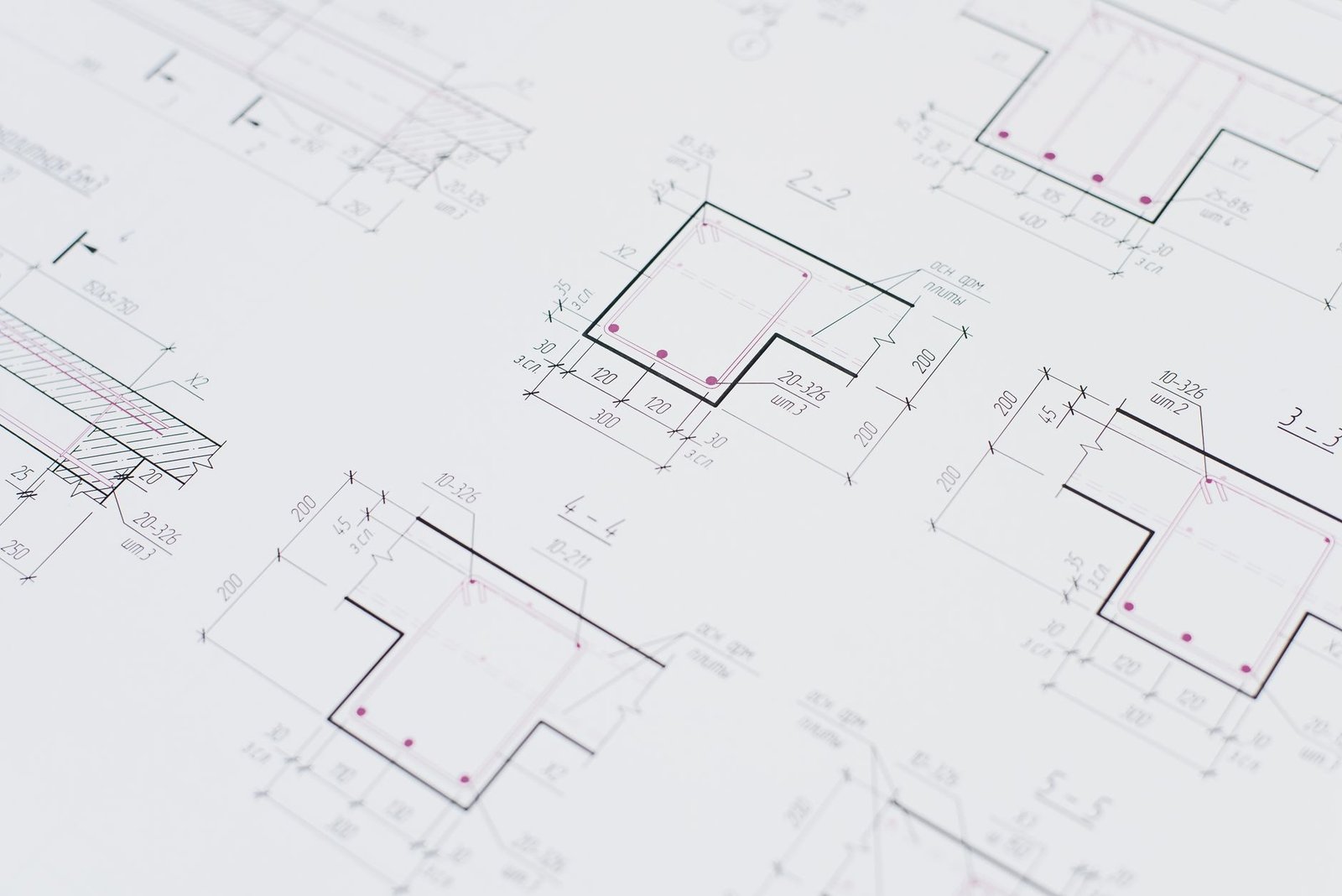 High-resolution close-up of detailed architectural blueprints showcasing precision design layouts.